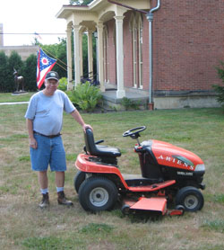 Terry Hobbs volunteers to mow the lawn of the Oberlin Heritage Center
